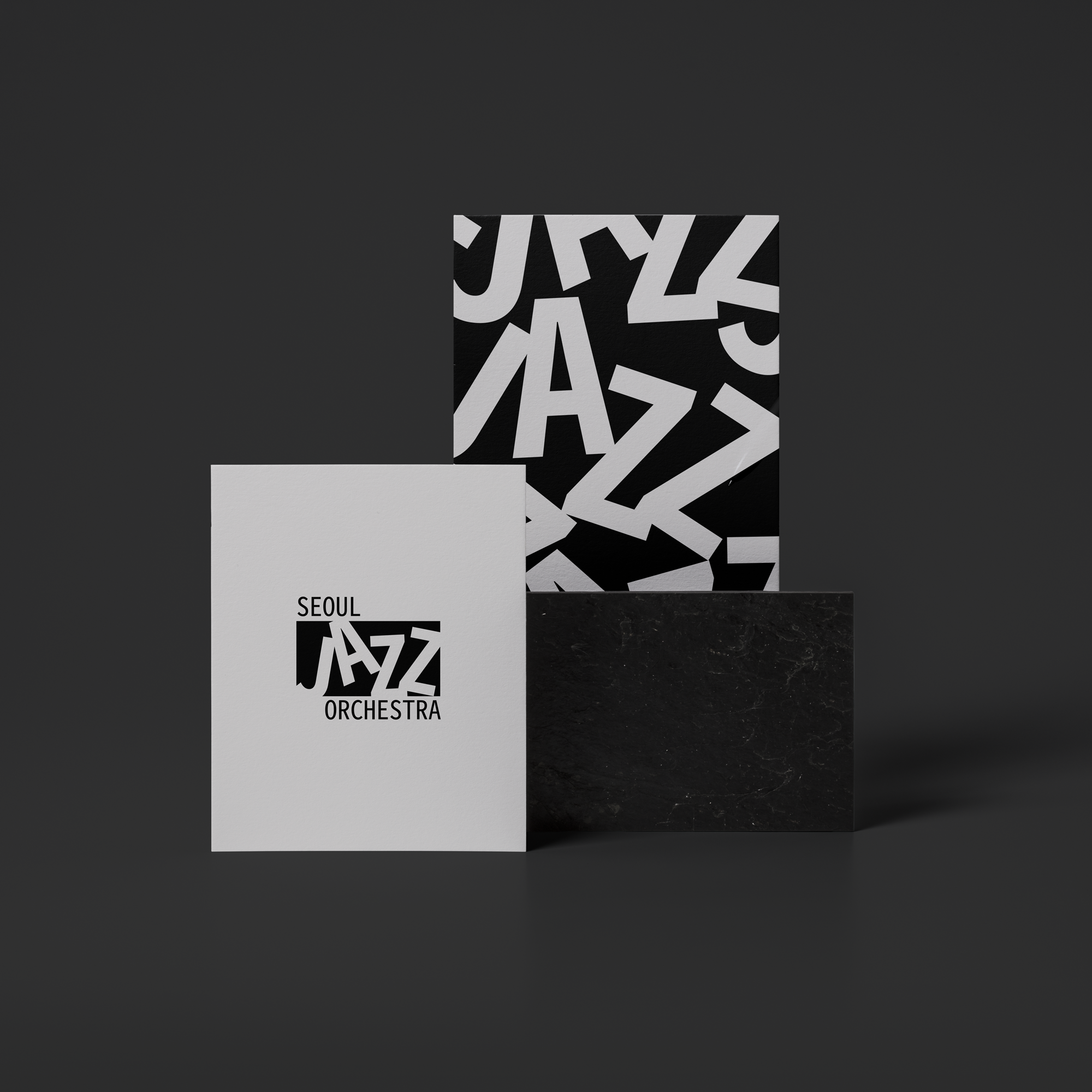 Graphic of a typography specimen showing the alphabet and numerals on top of a dark gray background.