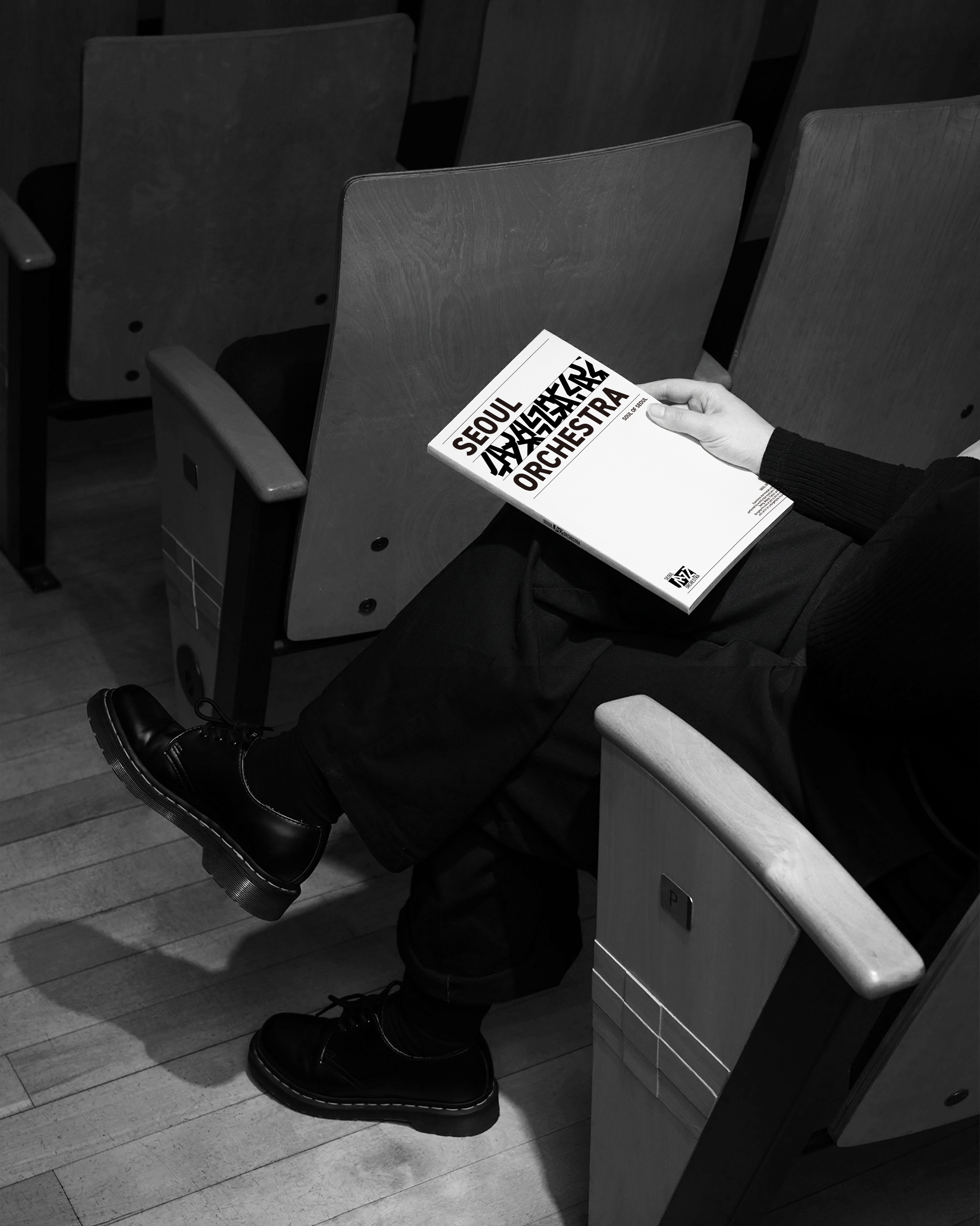 Graphic of a typography specimen showing the alphabet and numerals on top of a dark gray background.